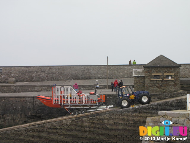SX14121 RNLI lifeboat being pulled onto harbour slipway by tracktor